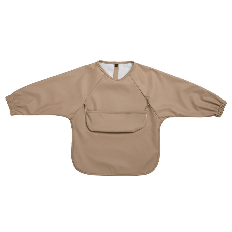 A beige waterproof long-sleeve smock for toddlers with a chest pocket.