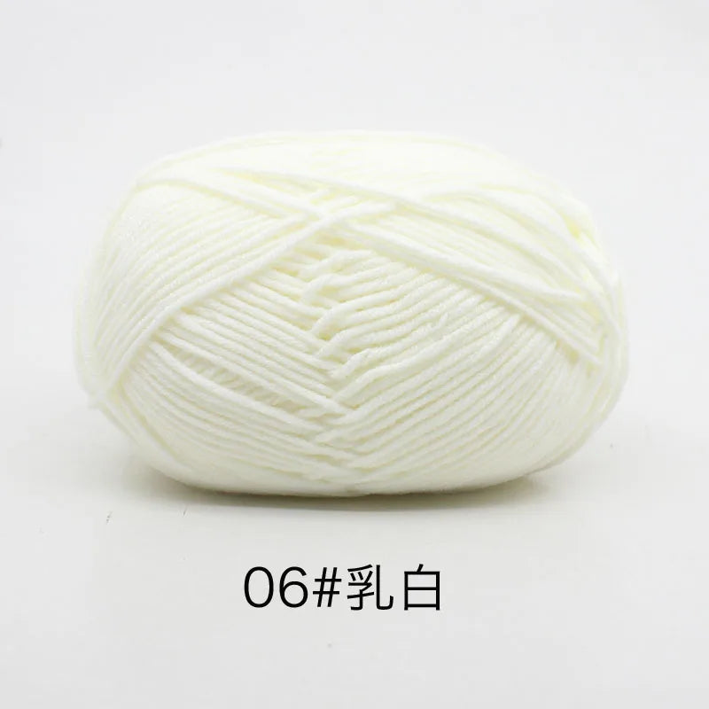A ball of white 4-ply milk cotton yarn for knitting and crochet.