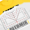 A white alignment ruler with red markings is shown on a yellow t-shirt, used for vinyl heat press alignment.
