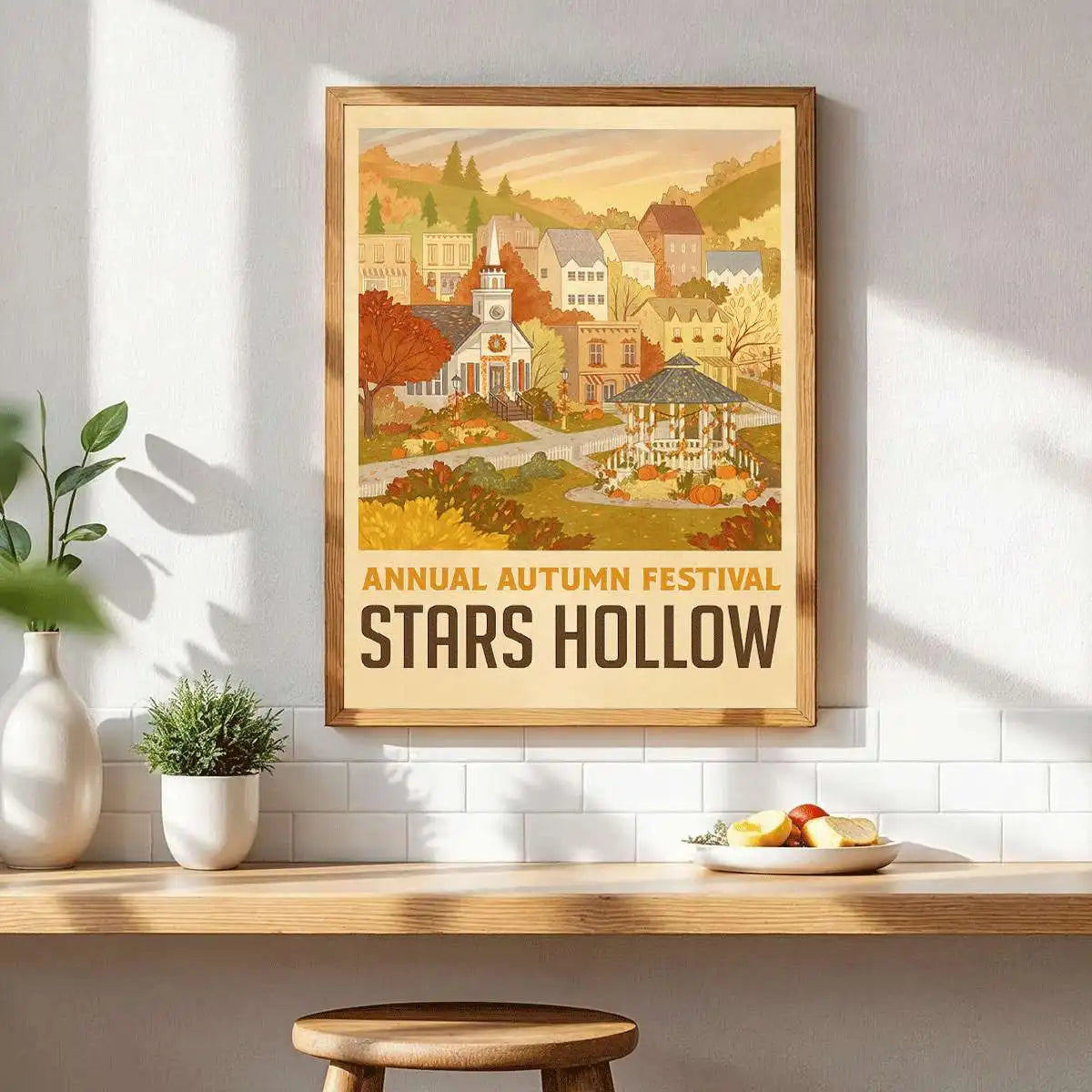 A framed canvas art print depicting a scenic autumn landscape with buildings and trees.
