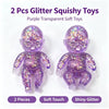 Two purple transparent squishy toys with glitter finish shown side by side