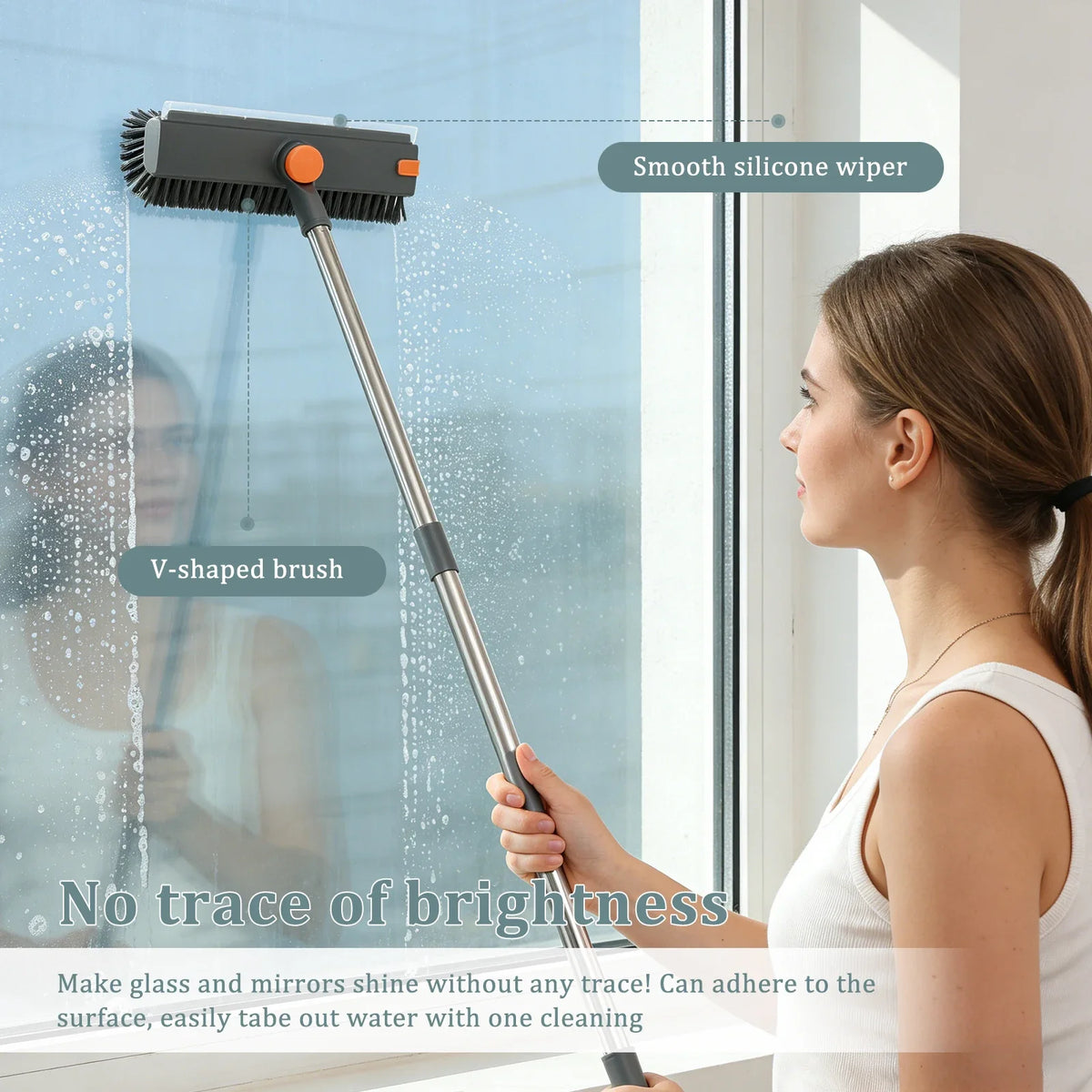A woman is using a 3-in-1 adjustable scrub brush with a smooth silicone wiper and V-shaped brush to clean a window.