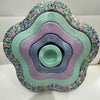 A colorful, multi-layered plastic balance stepping stone with a floral pattern.
