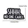 Black embroidered iron-on patch with the text SHHH. NO ONE CARES.