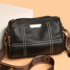 A black vintage genuine leather women's shoulder bag with a gold hardware detail and brown strap.