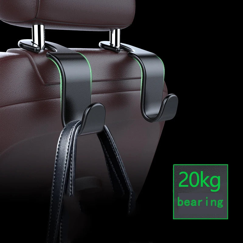 A close-up of a dark brown car seat headrest with black leather hooks and a green weight indicator labeled 20kg bearing.