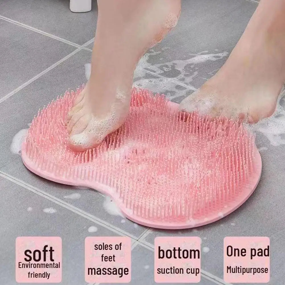 Pink silicone foot scrubber with a suction cup base being used on a tiled floor.
