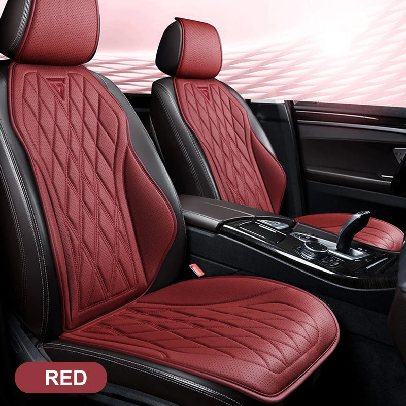 A close-up view of a red quilted leather car seat cover installed in a vehicle interior.