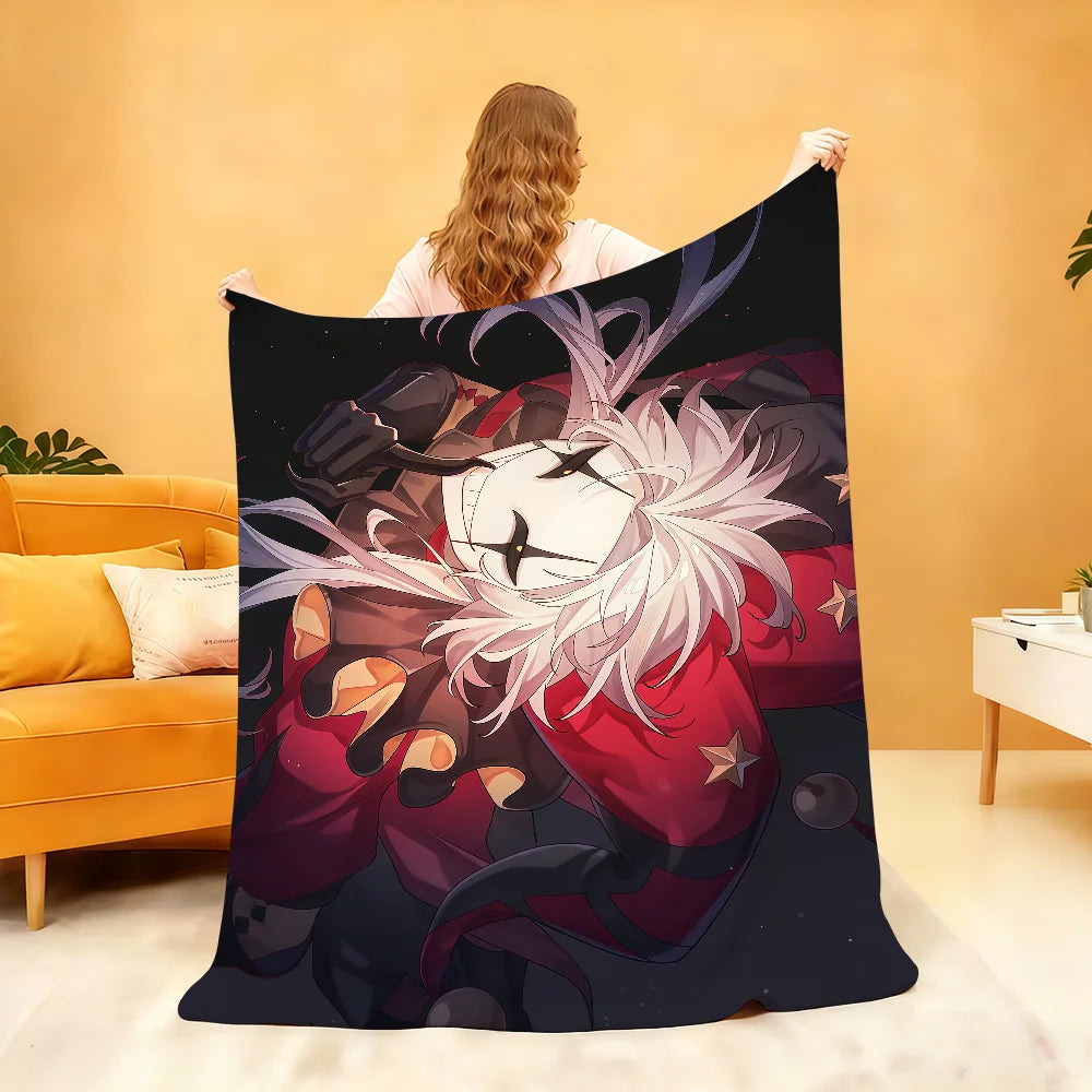 A dark graphic print of a character resembling Pierrot with white hair and red clothing on a throw blanket.