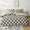 A checkered print bedding set featuring a duvet cover and pillowcases in black and beige tones.
