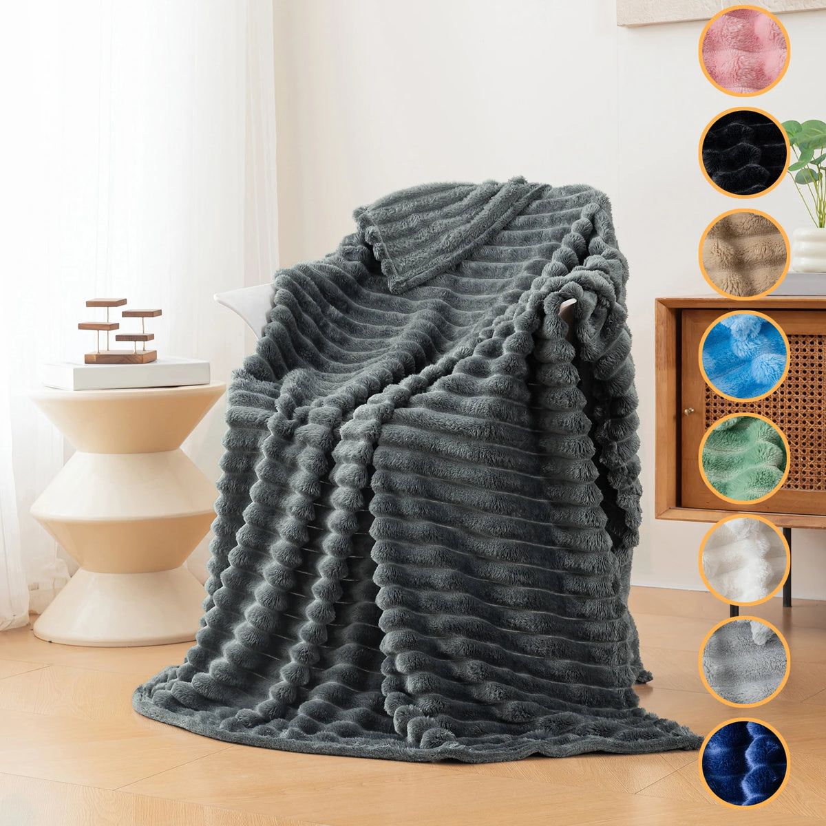 A gray brushed flannel throw blanket draped on a light-colored sofa, displayed next to color swatches.