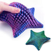 A purple 3D printed articulated starfish fidget toy with a textured surface and a green one nearby.
