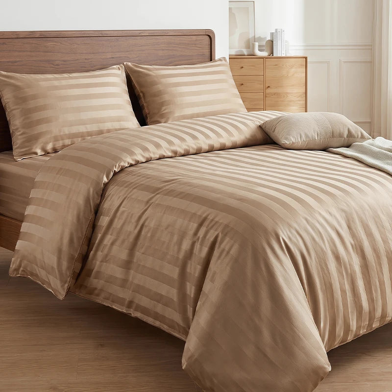 A beige satin striped jacquard duvet cover set displayed on a bed with wooden furniture.