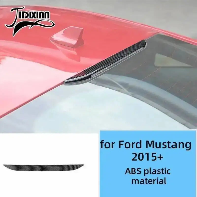 Close-up view of a red Ford Mustang interior trim piece featuring black carbon fiber grain decorative trim.