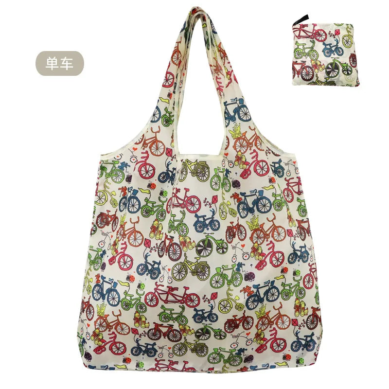 A reusable nylon shopping tote bag filled with various colorful bicycle-themed fabric patches.