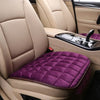 A close-up view of a beige car seat cover with a purple quilted seat protector and a black control panel.