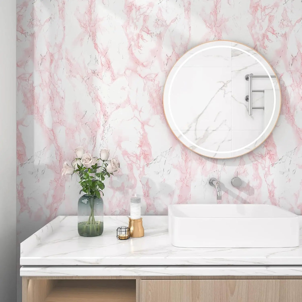 A white vessel sink and faucet are displayed on a marble countertop against a pink marbled wall.