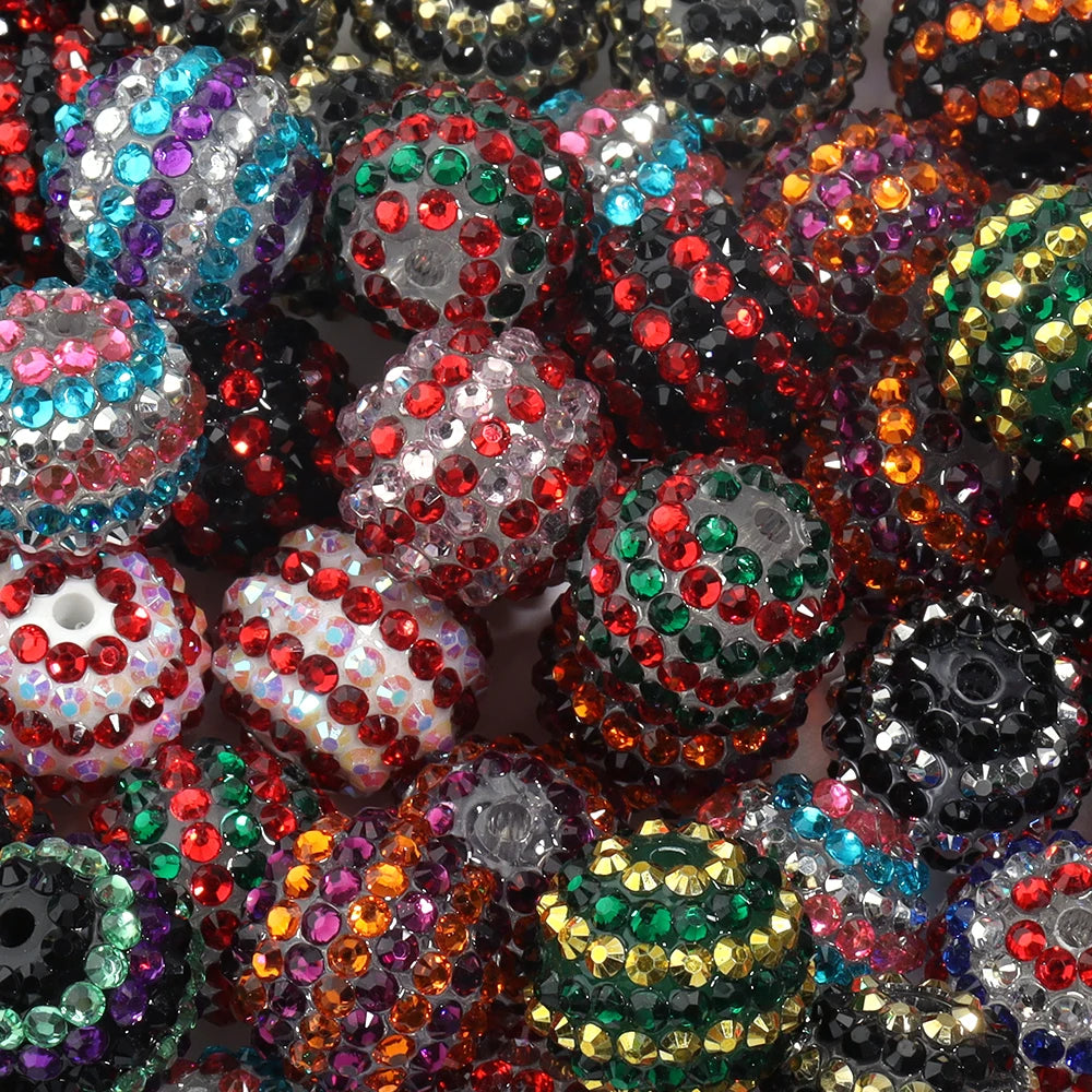 A close-up view of a set of resin rhinestone beads featuring various colors and two-tone striped designs.
