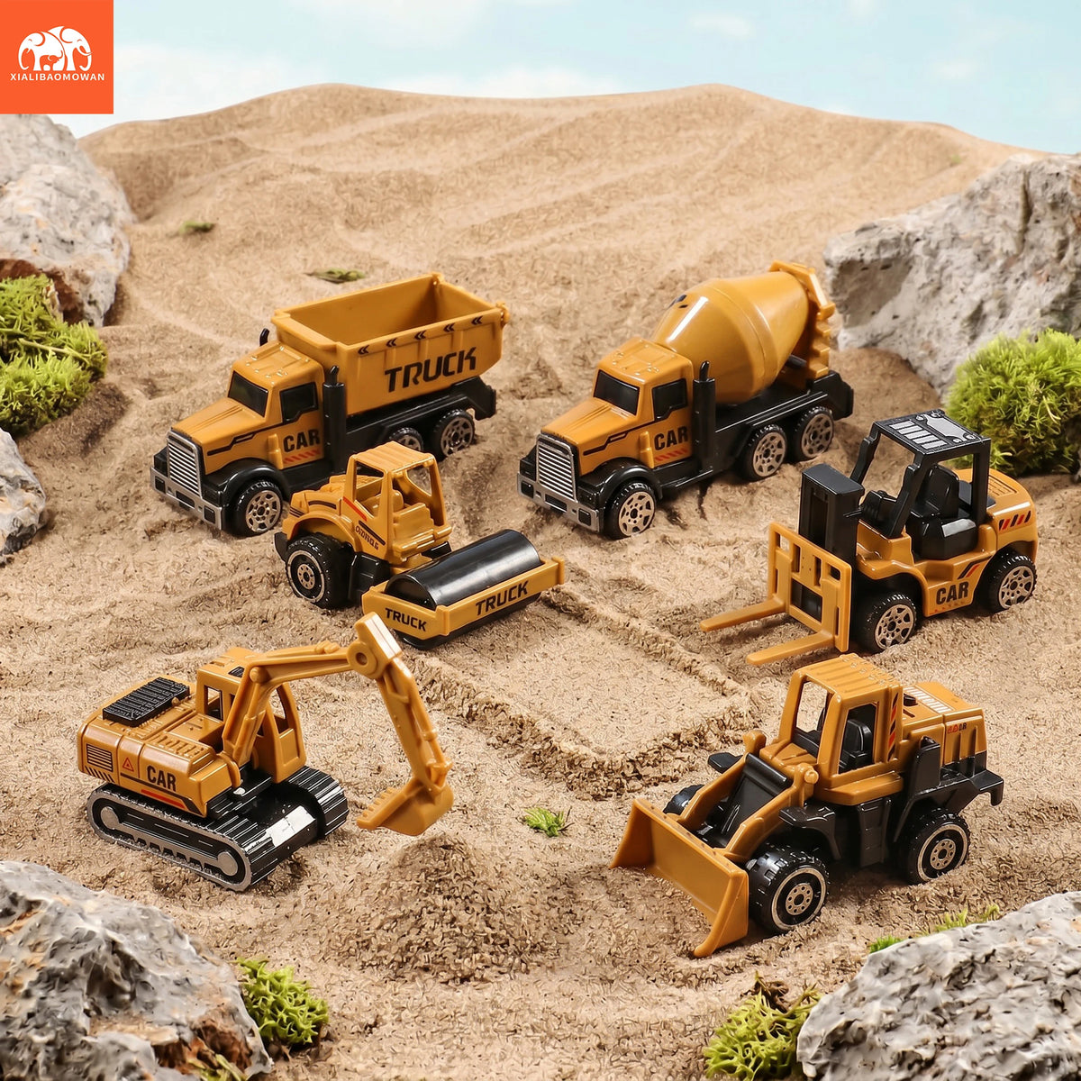A set of diecast alloy construction vehicles including a tractor, excavator, and truck toy on a sandy terrain.