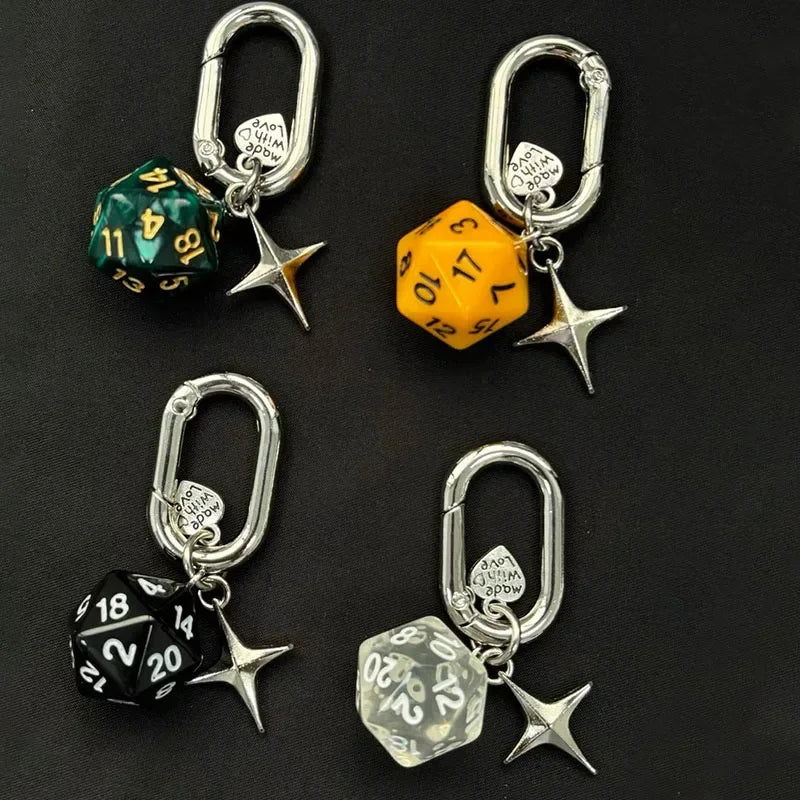 A collection of silver heart keychain charms featuring various colored dice shapes like green, yellow, and black.