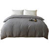 A solid gray washed cotton brushed duvet cover with white pillows on a bed.
