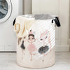 A beige storage basket with a unicorn ballerina print and black handles.