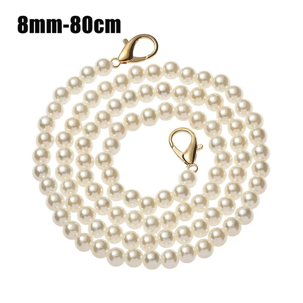 A strand of small, round, off-white pearls on a gold-toned chain with an adjustable clasp.