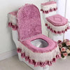 A pink antibacterial toilet seat cover set featuring a quilted cushion and lace trim.