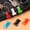 A set of colorful key holder clips in red, white, green, black, blue, and orange displayed on a black zippered pouch.
