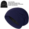 A navy blue silk satin sleep bonnet shown in a draped style.