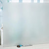 A clear frosted privacy window film panel with a stripe pattern resting on a white surface.