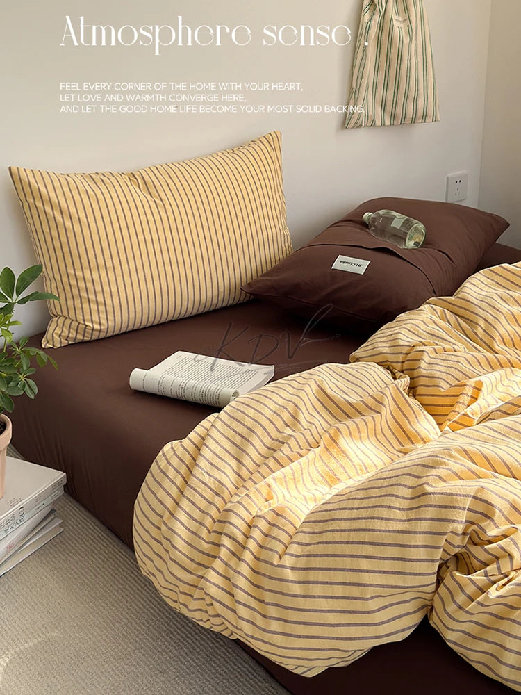 A brown bed with a striped yellow duvet cover and pillows, featuring text about atmosphere sense.