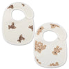 A pair of white baby cotton gauze bibs with a subtle beige pattern and waterproof backing.
