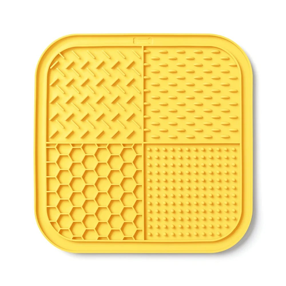 Yellow silicone lick mat for dogs and cats with suction cups featuring various textured patterns