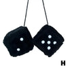 Black plush velvet dice with white dots suspended on a black cord