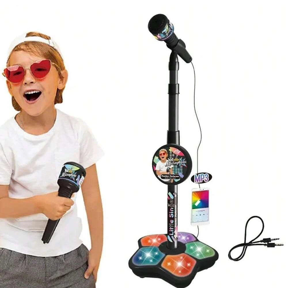 A child is holding a portable kids karaoke microphone with colorful light effects and an attached MP3 player.