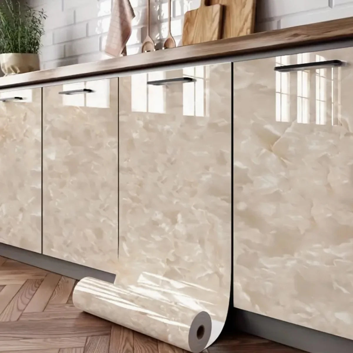 A close-up of light beige marble peel-and-stick wallpaper applied to kitchen cabinetry.