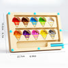 A wooden magnetic color sorting maze board with ten colored cups for toddlers