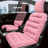 Pink plush car seat cover with cherry blossom powder texture installed in a dark vehicle interior.