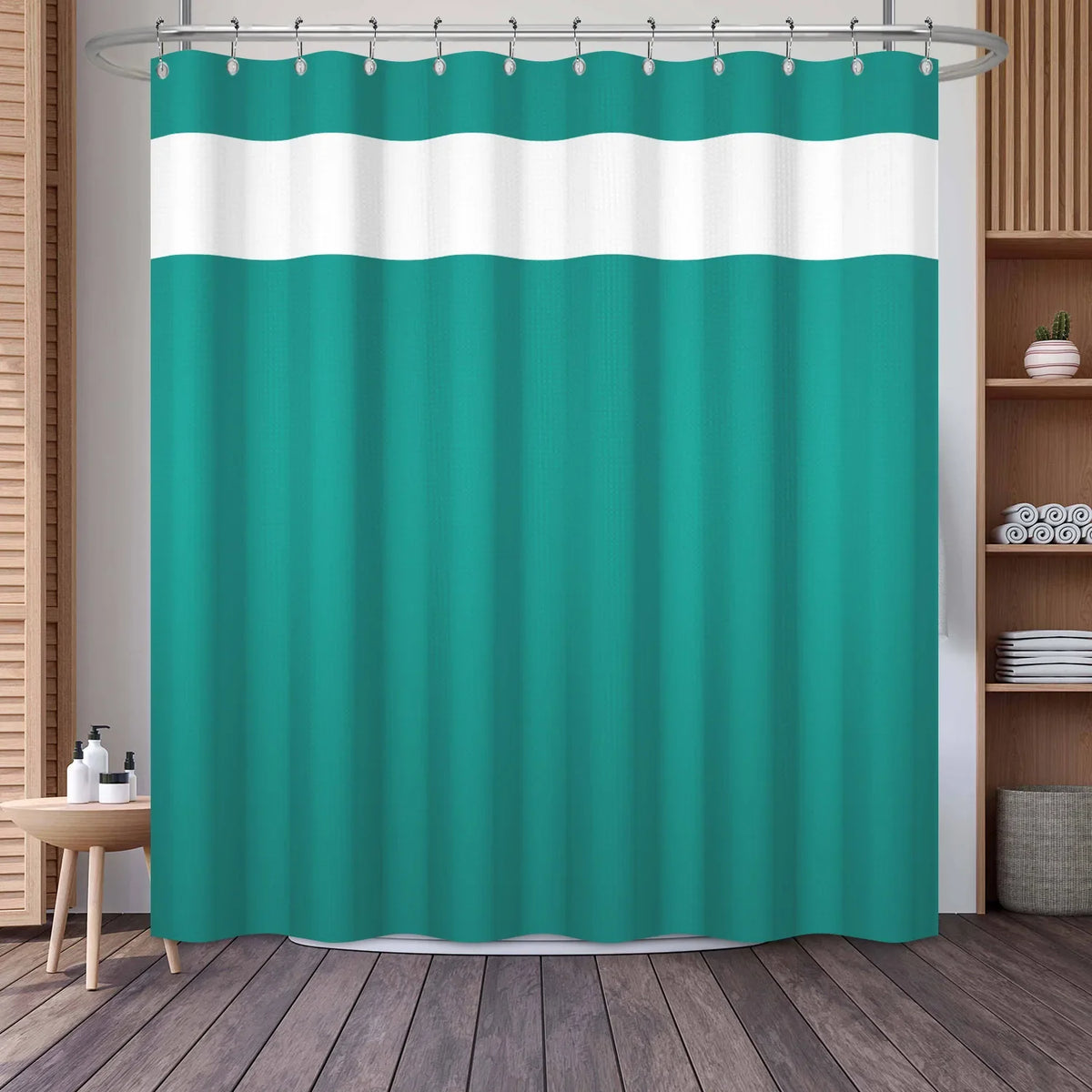 A teal shower curtain featuring a white geometric stripe pattern hanging on a rod.