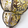 A close-up of a decorative metal solar hollow-out lantern with intricate cutout patterns.