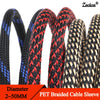 Close-up view of black and red braided PET cable sleeves showing various diameters for flexible wire protection.