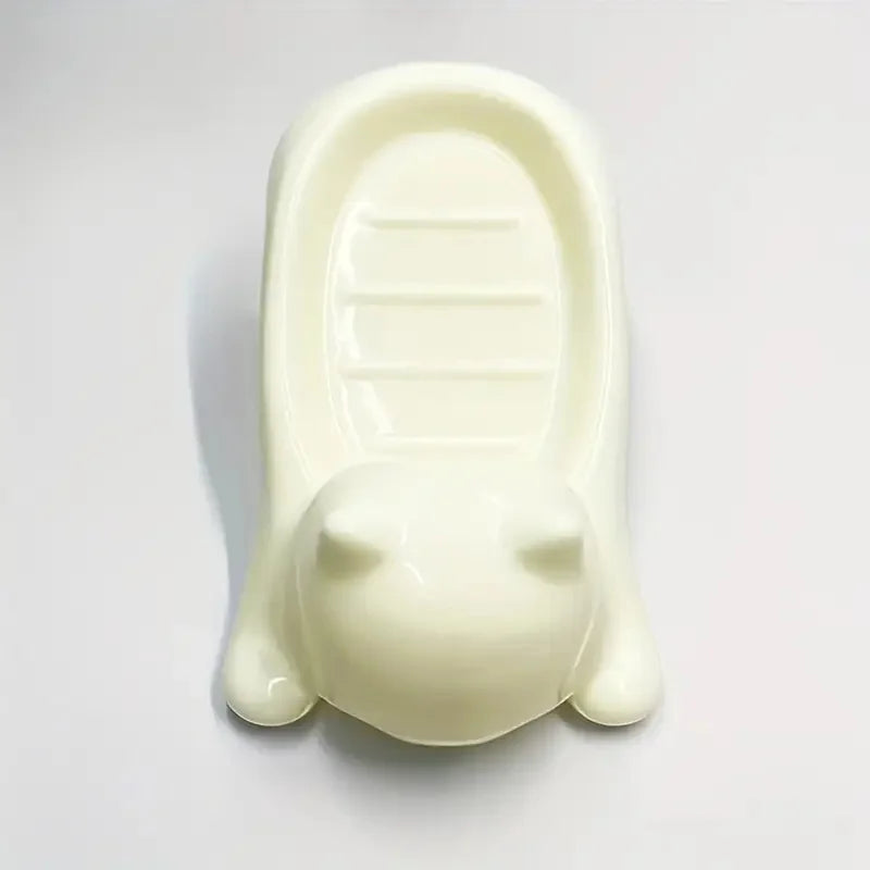 A white cat-shaped soap dish with a drainage tray.
