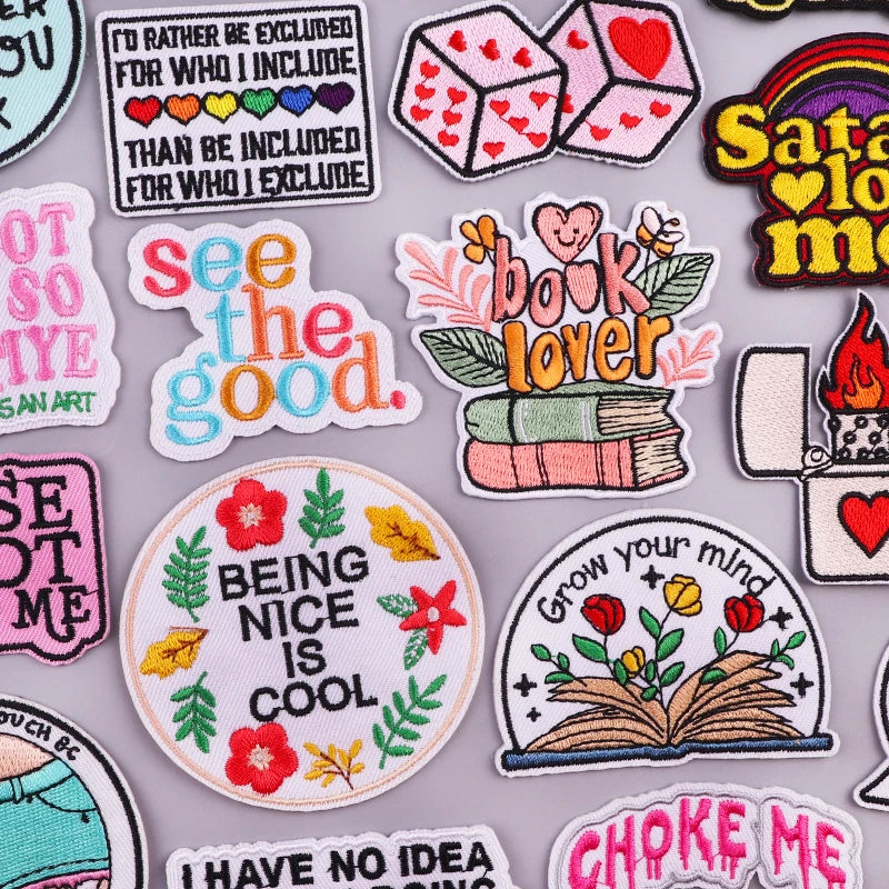 A collection of colorful embroidered iron-on patches featuring inspirational phrases and designs.