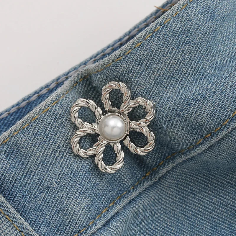 Silver pearl flower waist clip attached to a denim fabric