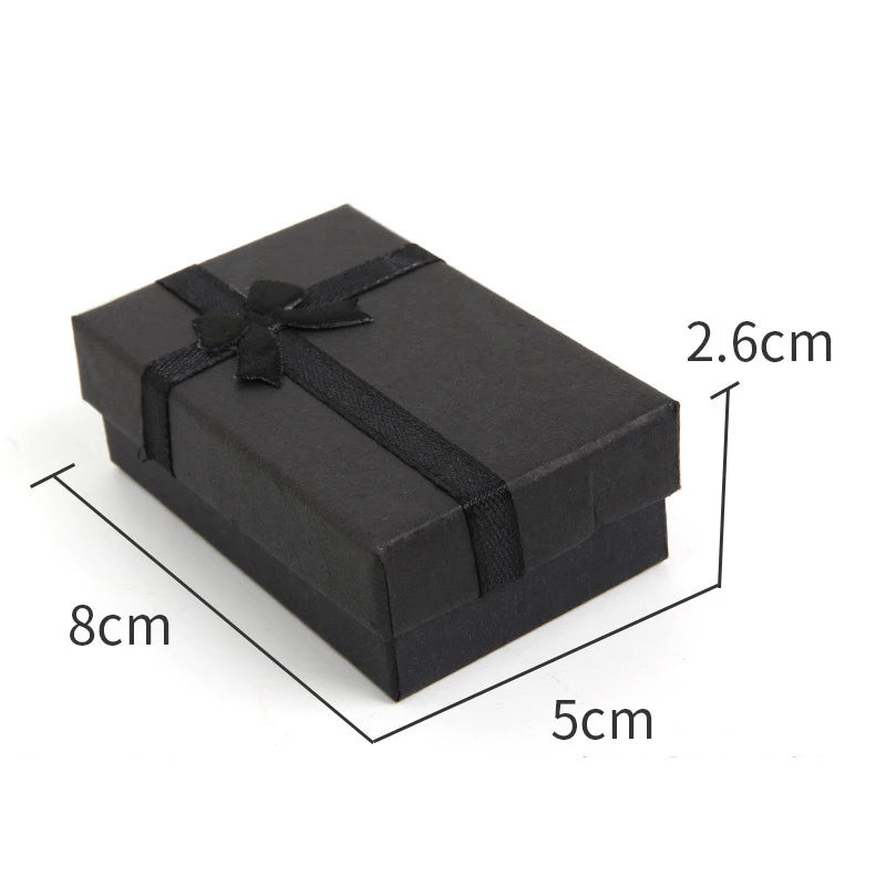 A black velvet jewelry gift box with a bow, shown from above and displaying its dimensions.