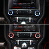 Close-up view of interior car audio controls and trim components for a Ford Mustang, featuring aluminum knob covers.