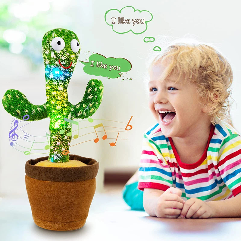 A happy toddler is interacting with a green cactus plush toy that lights up and plays music.