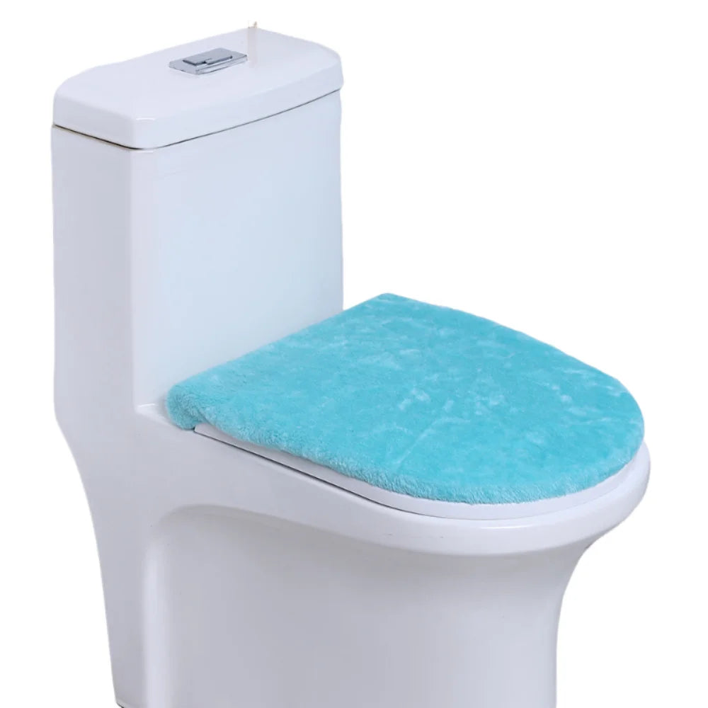 A white toilet with a light blue flannel seat cover installed.