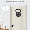 A black dumbbell shaped over-the-door hook is shown hanging on a white door, demonstrating its 10lb capacity.